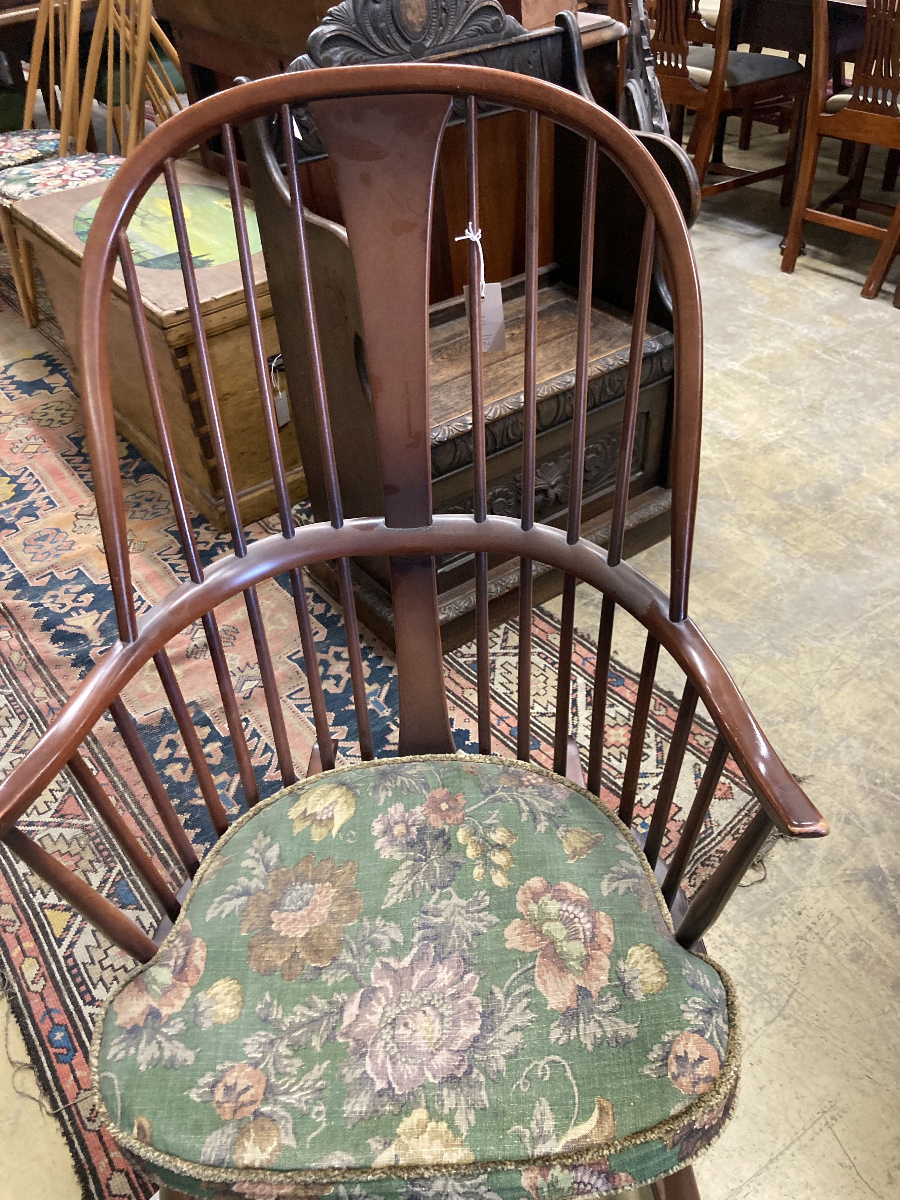 An Ercol comb back stained beech rocking chair, width 60cm, depth 50cm, height 106cm